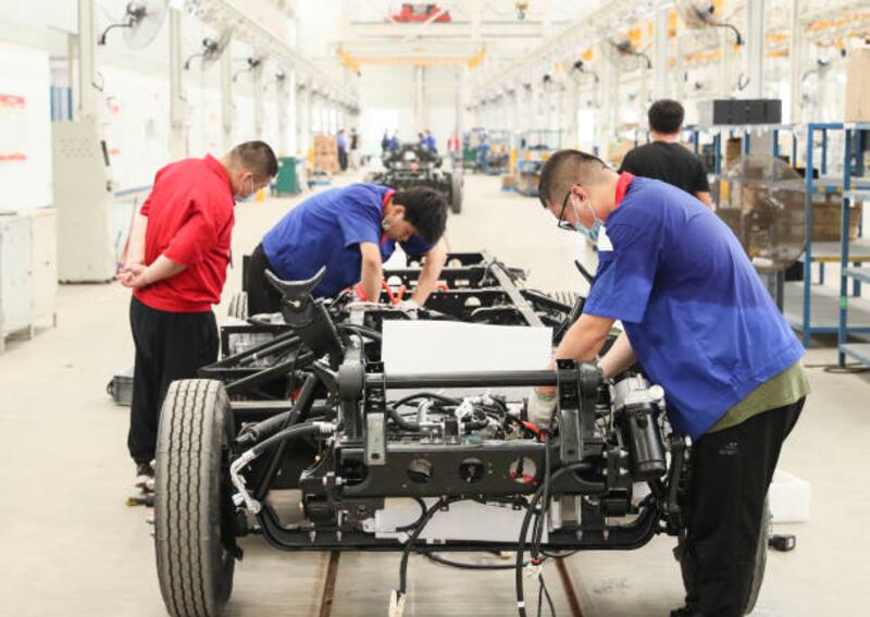 Workers assemble a BYD electric car in Huai'an, in east China's Jiangsu Province. Getty