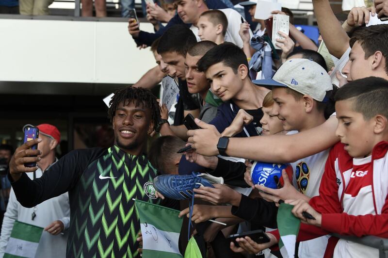 Alex Nigeria's forward Alex Iwobi poses for selfies with fans at the team's first training session at Essentuki Arena in southern Russia on June 12, 2018 ahead of Russia 2018 World Cup football tournament. / AFP / PIUS UTOMI EKPEI
