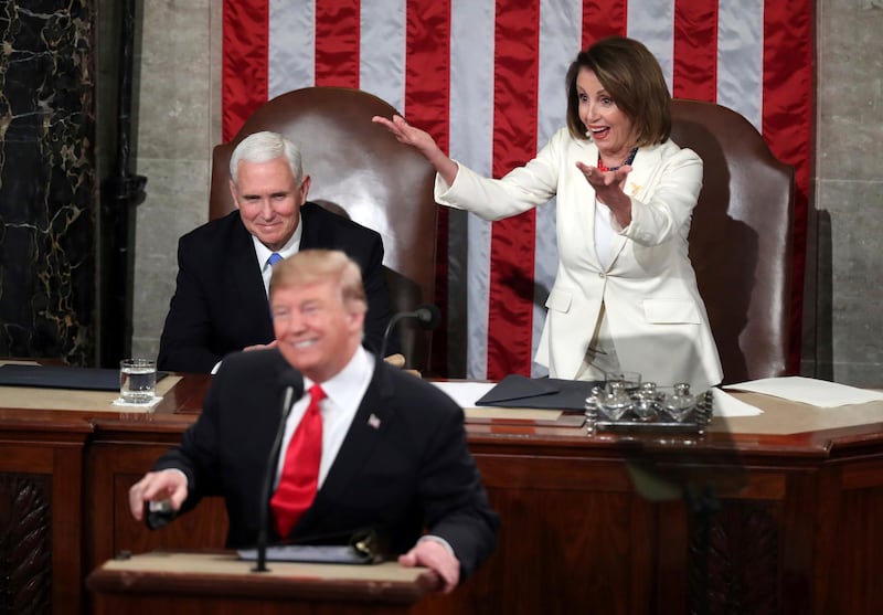 Nancy Pelosi gestures to fellow Democrats as Donald Trump acknowledges women in Congress during his State of the Union address. AP Photo