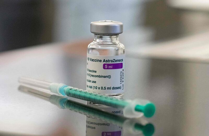 (FILES) In this file photo taken on February 12, 2021 a vial containing the Covid-19 vaccine by AstraZeneca and a syringe are seen on a table in the pharmacy of the vaccination center at the Robert Bosch hospital in Stuttgart, southern Germany. Colombia approved the use of the COVID-19 vaccine developed by the Oxford University and the AstraZeneca laboratory, from which 10 million doses are expected to arrive, authorities informed on February 23, 2021. / AFP / THOMAS KIENZLE
