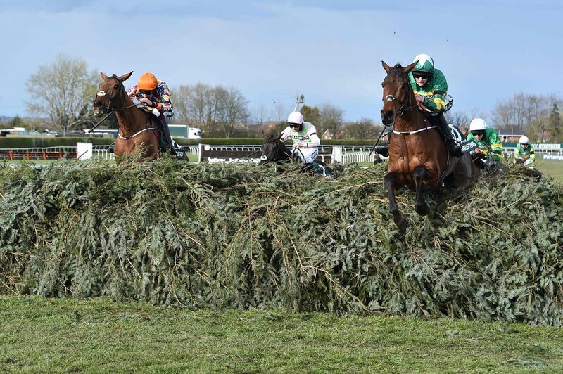 Jockey Racheal Blackmore rides Minella Times, right, ahead of second placed Aiden Coleman on Blako Des FLos at the Grand National. AFP