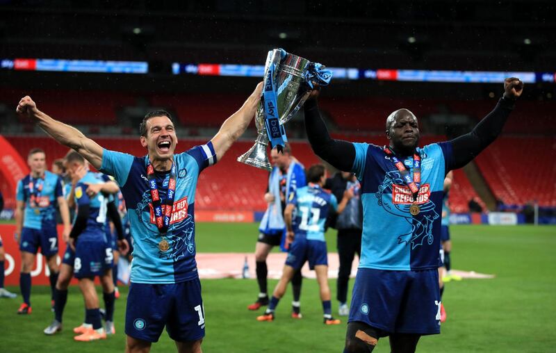 Wycombe Wanderers' Matt Bloomfield (left) and Adebayo Akinfenwa celebrate with the trophy. PA