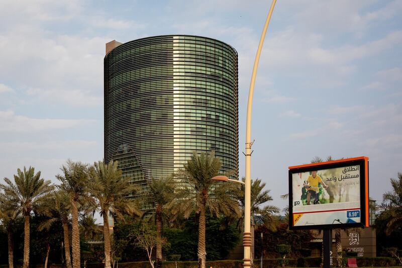 An advertisement for the Saudi Aramco initial public offering (IPO) stands on display beside a highway in Dhahran, Saudi Arabia. Bloomberg