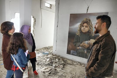 Palestinian artist Ali al-Jabali walks people through his haunting exhibit. Courtesy Fady Hanona