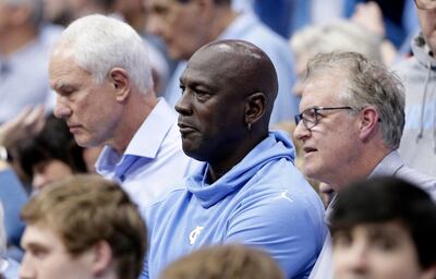 Charlotte Hornets owner and former North Carolina great Michael Jordan, center, watches North Carolina play Virginia during an NCAA college basketball game in Chapel Hill, N.C., Monday, Feb. 11, 2019. At right is former North Carolina player Buzz Peterson, assistant general manager of the Hornets, and at left is former North Carolina player Mitch Kupchak, general manager of the Hornets. Peterson knew Jordan as well as anyone when they were in college. Roommates and teammates at North Carolina, they spent countless days competing on the basketball court in practice and endless hours talking hoops. But Peterson never saw this coming: His roommate becoming an NBA owner and hosting the leagueâ€™s All-Star game in his home state of North Carolina. (AP Photo/Gerry Broome)