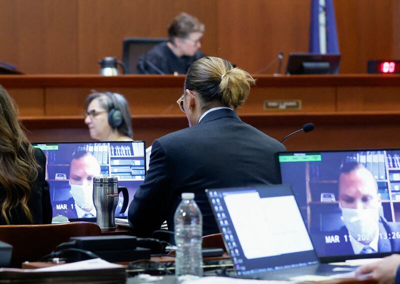 Depp watches a virtual deposition. AFP