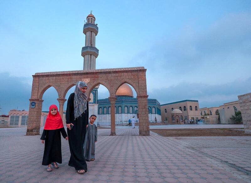 Abu Dhabi, U.A.E., August 21 , 2018.  Early morning prayers at the Masjid Bani Hashim mosque.  Asma Al Bayouk take her children, Hmymn and Yassin to the Women's prayer room with her for Eid prayers.
Victor Besa / The National
Section:  NA
Reporter:  Haneen Dajani