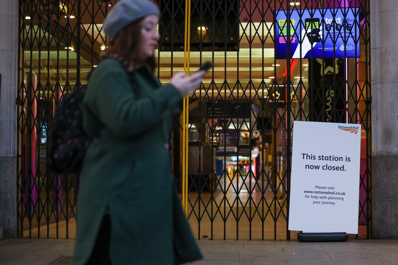 A commuter passes a closed entrance to London Victoria railway station. Bloomberg