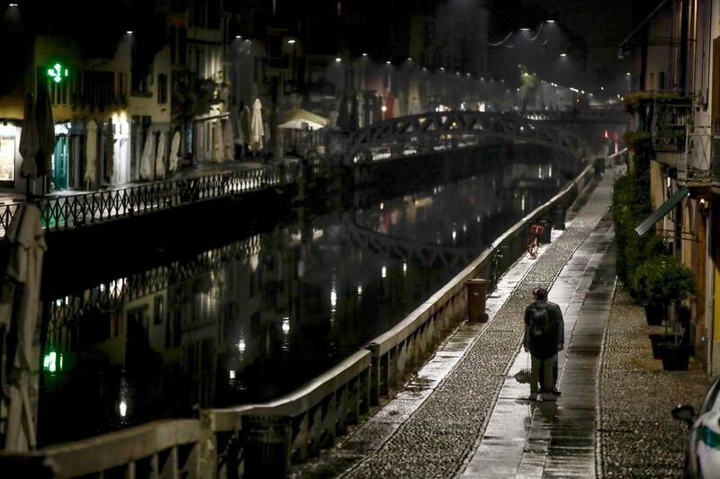 The unusually empty Navigli area, a popular evening spot of restaurants and pubs bordering canals in Milan, Italy. AP Photo