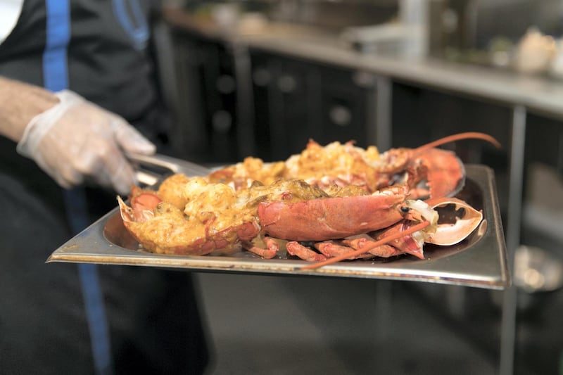 ABU DHABI, UNITED ARAB EMIRATES - MARCH 27, 2018. 

Chef Theodoris Rouvas, from Bentley Kitchen, prepares a Lobster Thermidor.

He takes the lobster out of the oven.

(Photo by Reem Mohammed/The National)

Reporter: 
Section: AC
