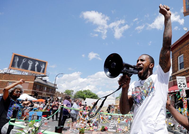 Community organiser Tommy McBrayer leads a chant in solidarity with George Floyd, at George Floyd Square, in Minneapolis. Reuters