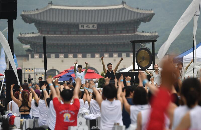 Participants take part in a mass yoga event at Gwanghwamun Square in Seoul.  Jung Yeon-je / AFP
