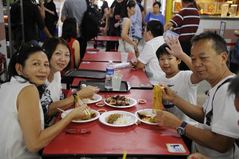 A family from Malaysia enjoying Chan’s Michelin-starred soya sauce chicken.