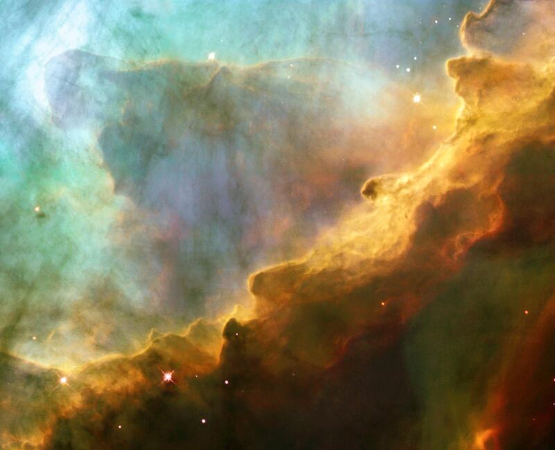In this sturning image provided by the Hubble Space Telescope (HST), the Omega Nebula (M17) resembles the fury of a raging sea, showing a bubbly ocean of glowing hydrogen gas and small amounts of other elements such as oxygen and sulfur. The nebula, also known as the Swan Nebula, is a hotbed of newly born stars residing 5,500 light-years away in the constellation Sagittarius. NASA