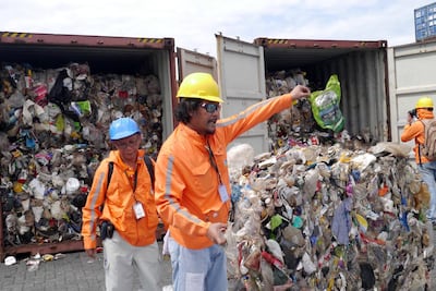 Philippine customs officials inspect cargo containers containing tonnes of garbage shipped by Canada at Manila port November 10, 2014. Picture taken November 10, 2014. Mandatory credit BAN Toxics/Handout via REUTERS ATTENTION EDITORS - THIS IMAGE HAS BEEN SUPPLIED BY A THIRD PARTY. NO RESALES. NO ARCHIVES. MANDATORY CREDIT