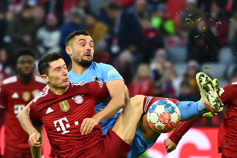 Bayern's Robert Lewandowski in action against Freiburg's Manuel Gulde. EPA