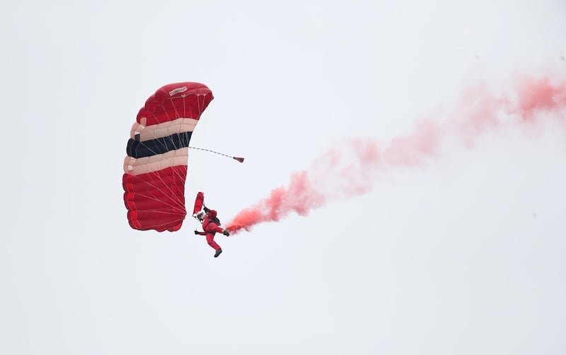 A member of The Red Devils parachute display team before the match. Reuters