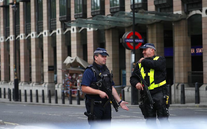 Armed police stand in the street after a car crashed outside the Houses of Parliament in Westminster, London, Britain, August 14, 2018. REUTERS/Hannah McKay