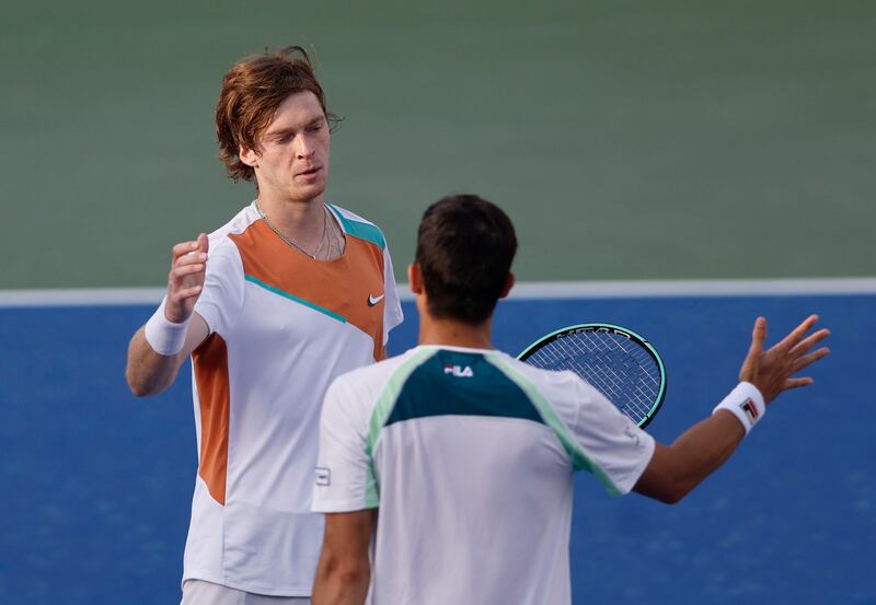 Andrey Rublev and Mackenzie McDonald greet each other at the net after their quarter-final match. Reuters