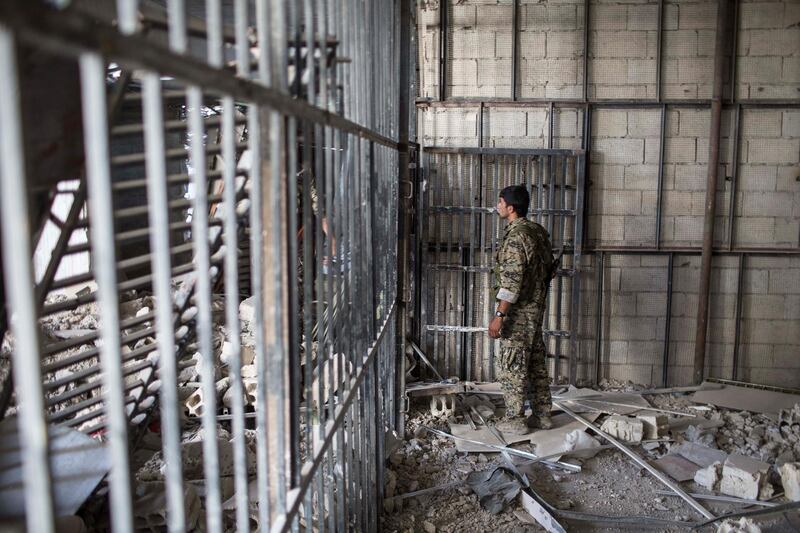 A members of the U.S.-backed Syrian Democratic Forces (SDF) walk inside a prison built by Islamic State fighters at the stadium that was the site of Islamic State fighters' last stand in the city of Raqqa, Syria, Friday, Oct. 20, 2017. The SDF on Friday declared from the stadium during a ceremony the "total liberation" of Raqqa, the capital of the Islamic State for more than three years. (Photo/Asmaa Waguih)