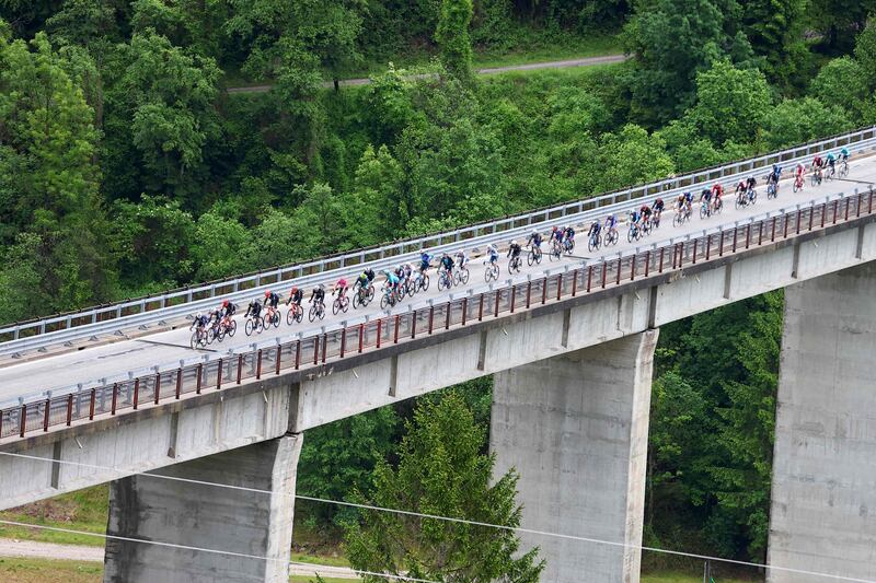 The peloton rides on the Ponte di Ronco in Ronco Scrivia. AFP