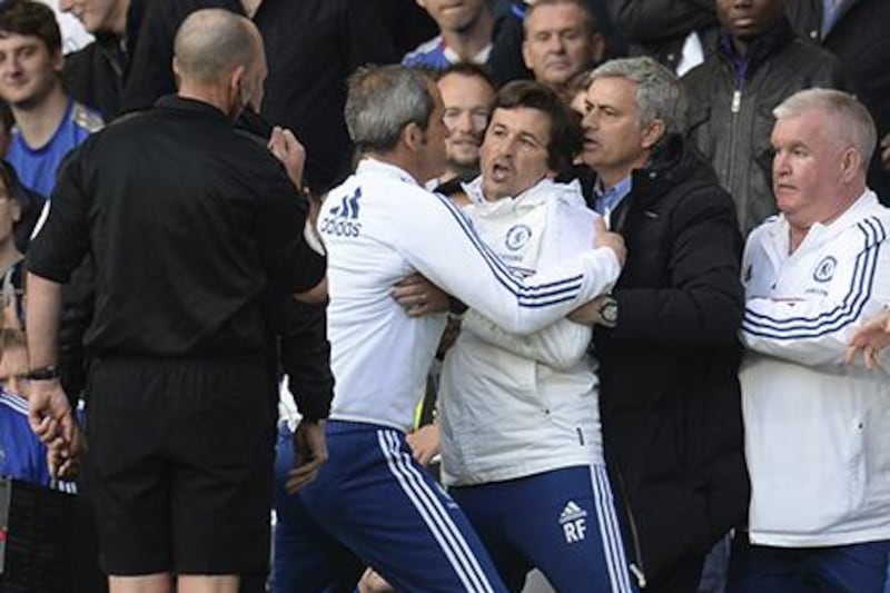 Chelsea’s manager Jose Mourinho, second from right, holds back assistant coach Rui Faria, centre, after he was sent off by referee Mike Dean, left, during their Premier League match against Sunderland at Stamford Bridge in London. Philip Brown / Reuters