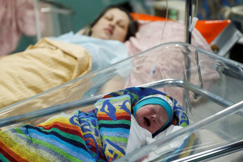 Newborn Ivan lies next to his mother as they shelter in the basement of a Kyiv perinatal centre. Reuters