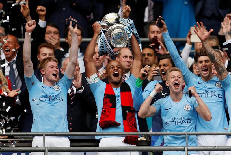 Manchester City's Vincent Kompany lifts the FA Cup after leading City to a 6-0 victory over Watford at Wembley. Reuters