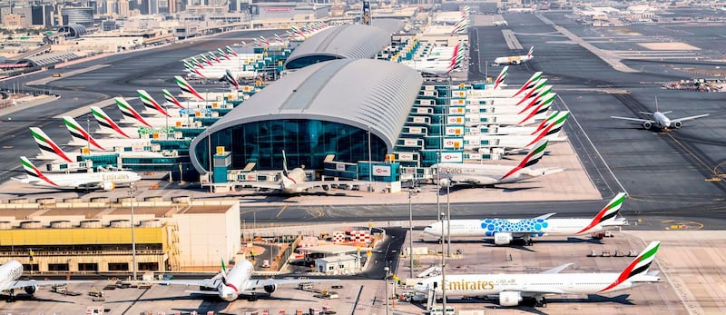 Parked Emirates planes on the tarmac at Dubai International Airport.