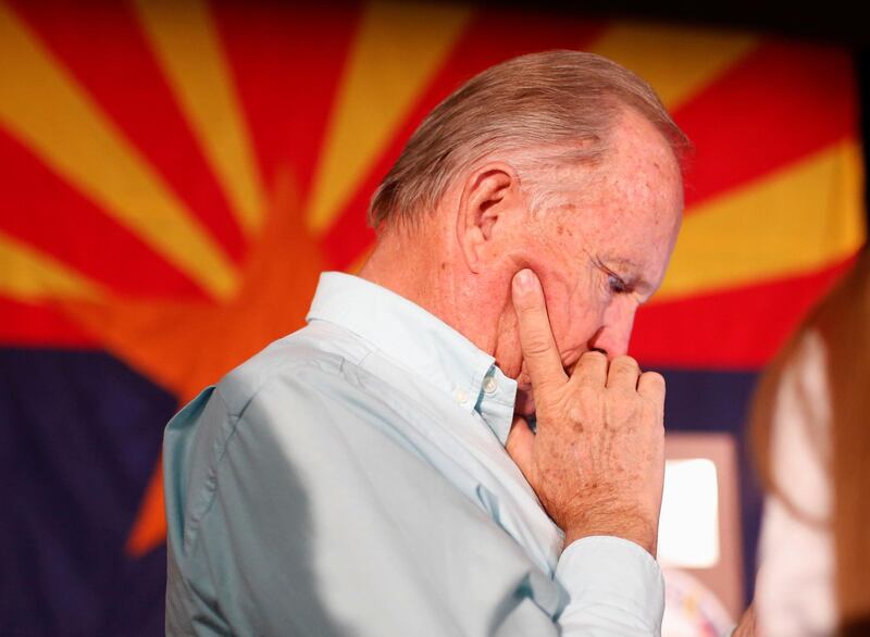 Supporter Mike Gipson checks results on his phone at the GOP watch party in Arizona. Reuters