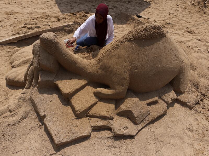Fatma El Zahraa, a teacher at Matrouh University, from Aswan, works on 'Camel with Bedouin lady'