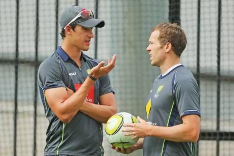 Australia fast bowlers Mitchell Starc and Peter Siddle chat during training.