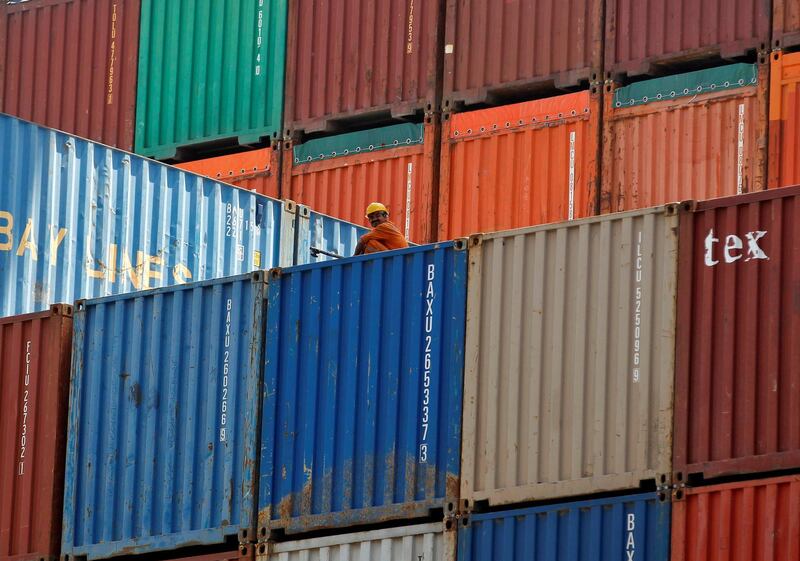 FILE PHOTO - A worker sits on a ship carrying containers at Mundra Port in the western Indian state of Gujarat April 1, 2014. REUTERS/Amit Dave/File Photo/File Photo
