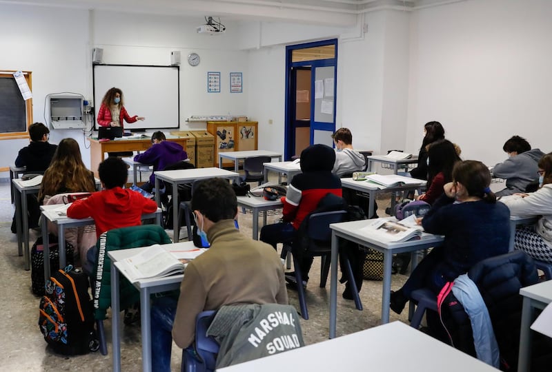 Middle school children listen to the teacher after returning to the classroom at the Cesare Piva school in Rome. Reuters