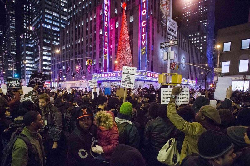Protesters in New York demand justice for the death of Eric Garner, as they march past Radio City Music Hall in the Manhattan borough on December 3, 2014. The grand jury decided not to charge white police officer Daniel Pantaleo in the chokehold death of the unarmed black man. Adrees Latif / Reuters