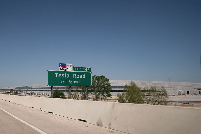 A Tesla Road exit sign on the Toll 130 motorway points to the new Gigafactory in Austin, Texas.   AFP