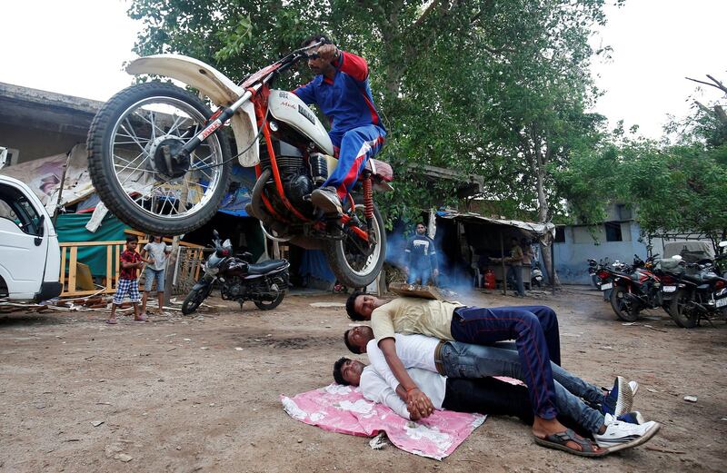 A Hindu devotee performs a stunt with his motorcycle during rehearsals ahead of the annual Rath Yatra, or chariot procession, in Ahmedabad, India. Amit Dave / Reuters