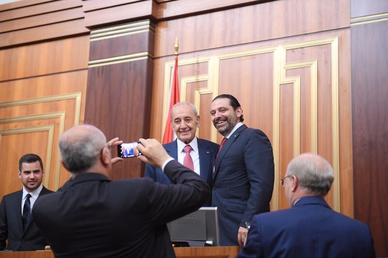 Lebanon's Finance Minister Ali Hassan Khalil takes photos of the parliamentary re-elected speaker Nabih Berri with outgoing Prime Minister Saad al-Hariri at the parliament in Beirut, Lebanon May 23, 2018. Lebanese Parliament/Handout via REUTERS ATTENTION EDITORS - THIS IMAGE WAS PROVIDED BY A THIRD PARTY