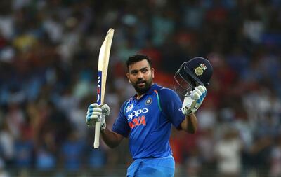 India's captain Rohit Sharma raises his bat and helmet to celebrate scoring a century during the one day international cricket match of Asia Cup between India and Pakistan in Dubai, United Arab Emirates, Sunday, Sept. 23, 2018. (AP Photo/Aijaz Rahi)