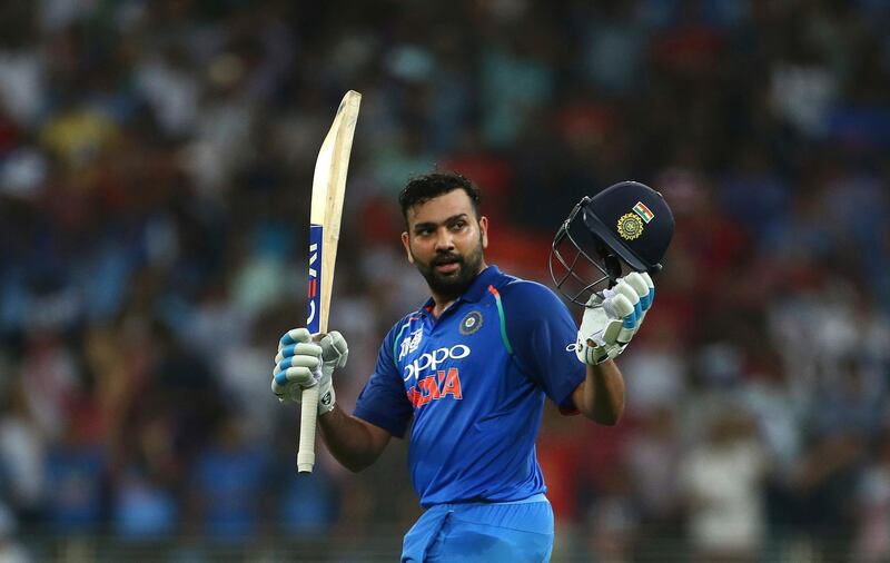 India's captain Rohit Sharma raises his bat and helmet to celebrate scoring a century during the one day international cricket match of Asia Cup between India and Pakistan in Dubai, United Arab Emirates, Sunday, Sept. 23, 2018. (AP Photo/Aijaz Rahi)