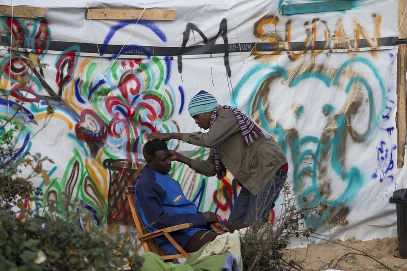 A migrant gets a shave at the Jungle migrant camp in Calais, France. Stephen Lock for The National
