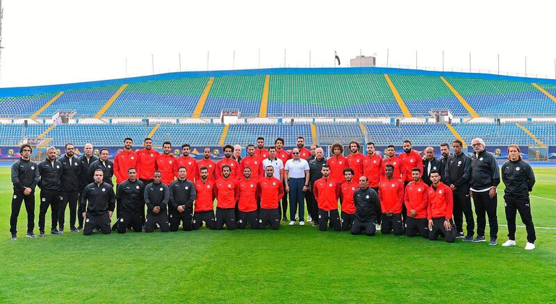 President Abdel Fattah El Sisi poses with the Egyptian football team at their training camp in Cairo ahead of the Africa Cup of Nations being hosted by Egypt.  AFP