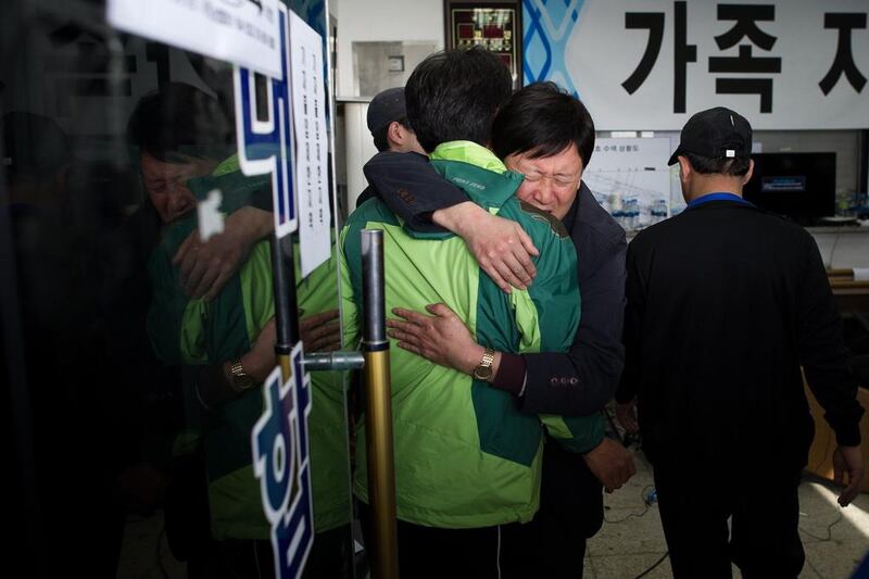 Relatives of victims of the ‘Sewol’ ferry embrace following scuffles that broke out at Jindo harbour. The confirmed death toll on April 24 stood at 171, but 131 were still missing as dive teams searched in near pitch-black conditions for bodies trapped in the ferry’s interior. Nicolas Asfouri / AFP Photo