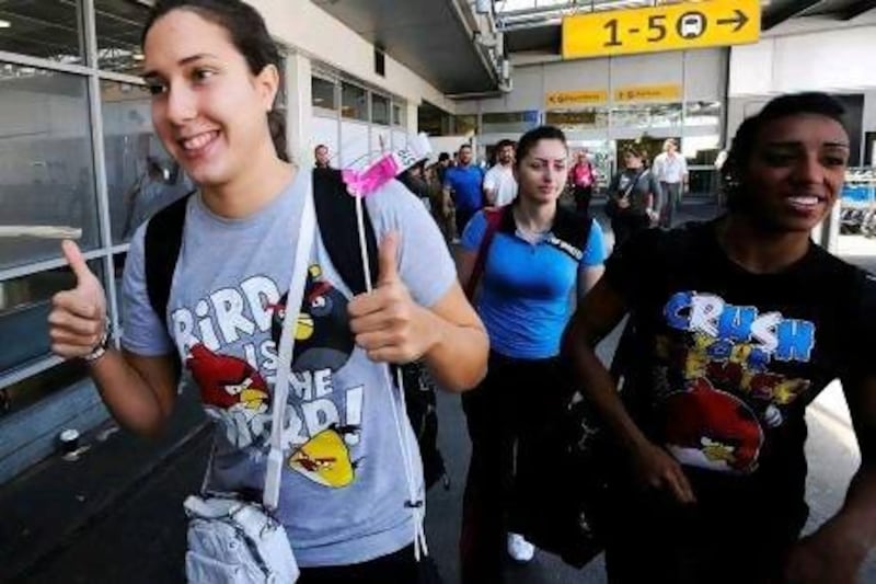 Members of the Syrian swimming team arrive at Heathrow airport, London, on July 23, 2012, four days ahead of the official opening of the London 2012 Olympic Games. AFP PHOTO
 *** Local Caption *** 046781-01-08.jpg