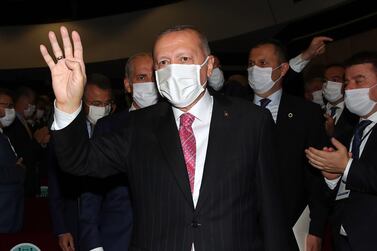 President Erdogan holds up his hand in the Rabia or Rabaa four finger sign of the Muslim Brotherhood. AFP