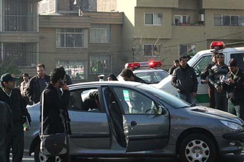 CORRECTS ID OF SCIENTIST-- 
In this image made available by the Iranian FARS news agency on November 29, 2010, police are seen standing close to a vehicle allegedly belonging to nuclear scientist Fereydoon Abbasi who was injured along with his wife when a motorcycle approached the vehicle and attached a bomb to it, close to the university where he was on his way to work in Tehran, one of two attacks on the same day against prominent nuclear scientists. EDS NOTE: AFP IS NOT RESPONSIBLE FOR ANY DIGITAL ALTERATIONS TO THIS PICTURE'S EDITORIAL CONTENT, DATE AND LOCATION WHICH CANNOT BE INDEPENDENTLY VERIFIED 
AFP PHOTO/FARS NEWS AGENCY/STR