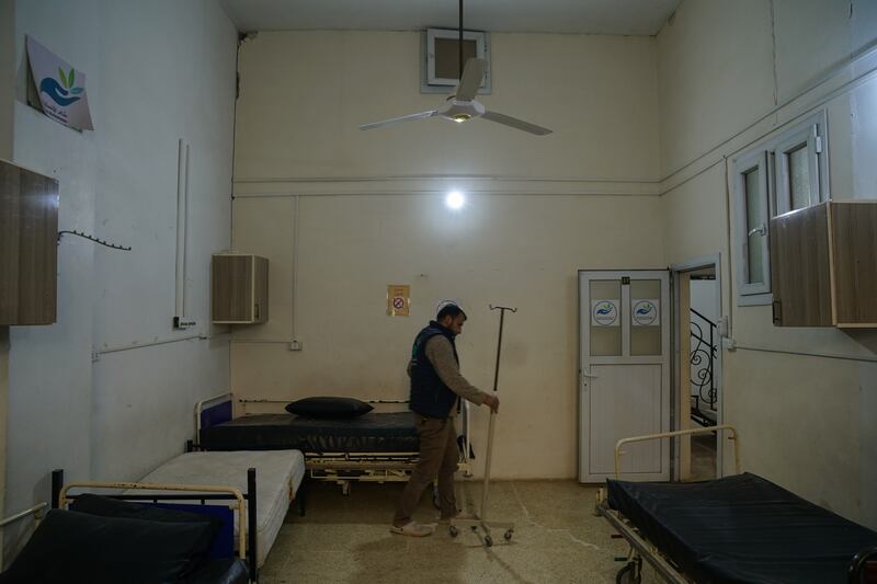 Mr Hamoud moves medical equipment from damaged rooms