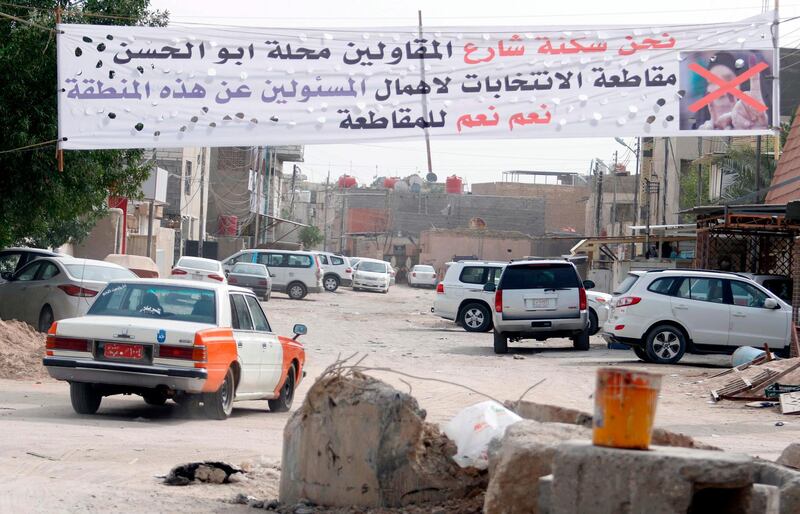 A banner calling voters to boycott the parliamentary elections in Iraq hangs in a neighbourhood in the southern city of Basra on May 8, 2018 as residents feel they are neglected by the federal government. 
Iraqi goes to the poll on May 12. / AFP PHOTO / HAIDAR MOHAMMED ALI