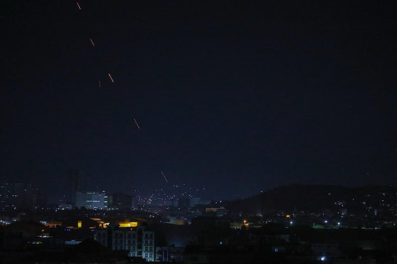 Celebratory gunfire light up part of the night sky after the last US aircraft took off from the airport in Kabul early on August 31, 2021. AFP