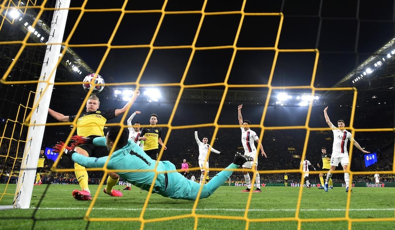 DORTMUND, GERMANY - FEBRUARY 18: Erling Haaland of Borussia Dortmund scores his team's first goal past Keylor Navas of Paris Saint-Germain during the UEFA Champions League round of 16 first leg match between Borussia Dortmund and Paris Saint-Germain at Signal Iduna Park on February 18, 2020 in Dortmund, Germany. (Photo by Stuart Franklin/Bongarts/Getty Images)